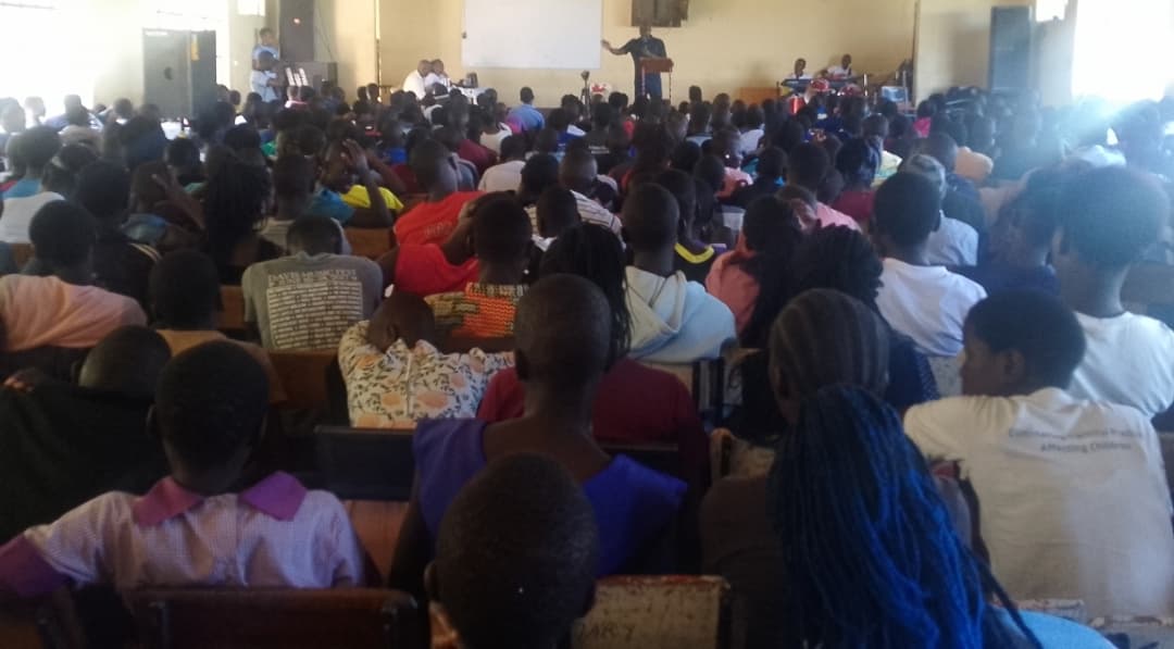 Children in rural Kenya raising their hands